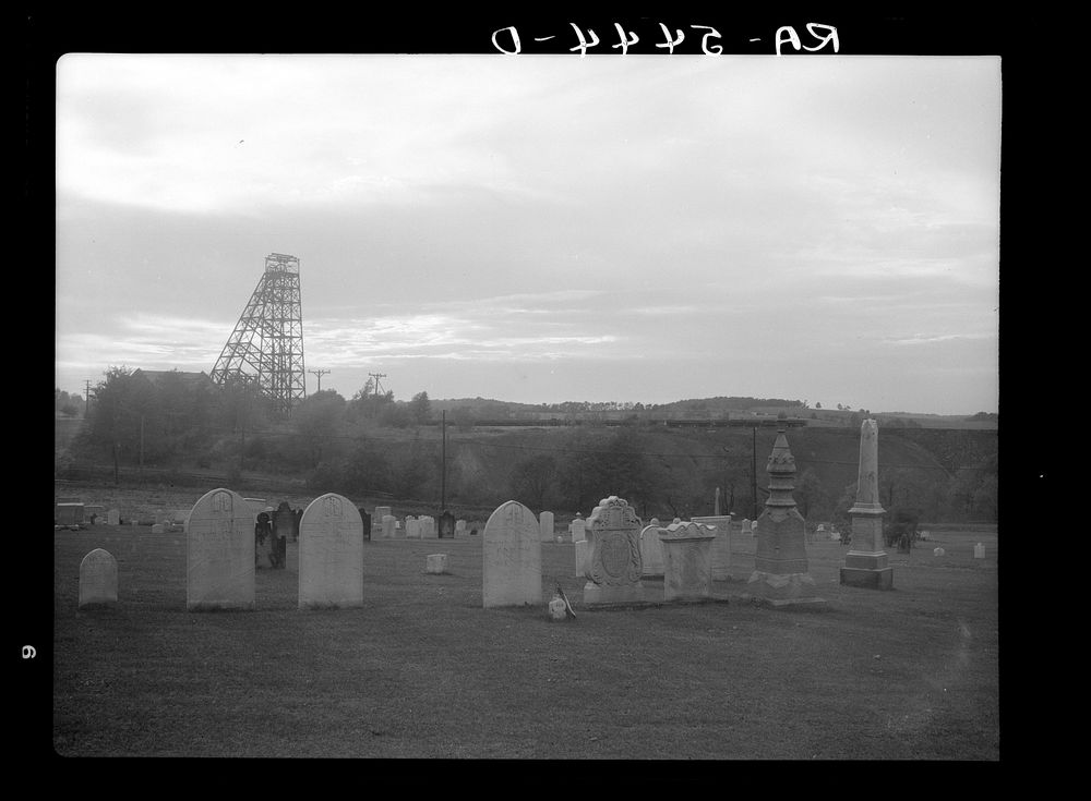 Cemetery across the tracks from an abandoned coal mine. Westmoreland County, Pennsylvania. Sourced from the Library of…