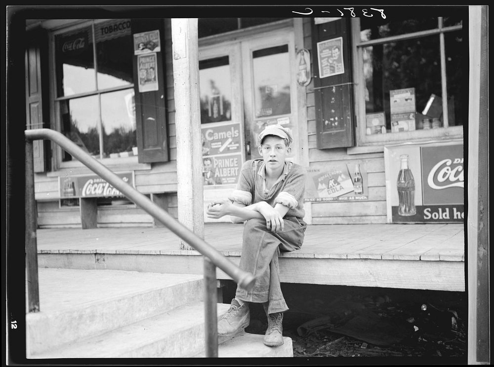 Boy on porch of general store. Roseland, Virginia. Sourced from the Library of Congress.