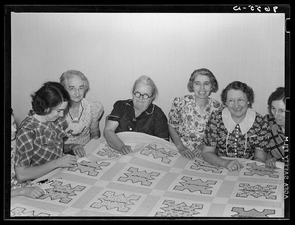 Ladies of the Helping Hand society working on quilt. Gage County, Nebraska. Sourced from the Library of Congress.