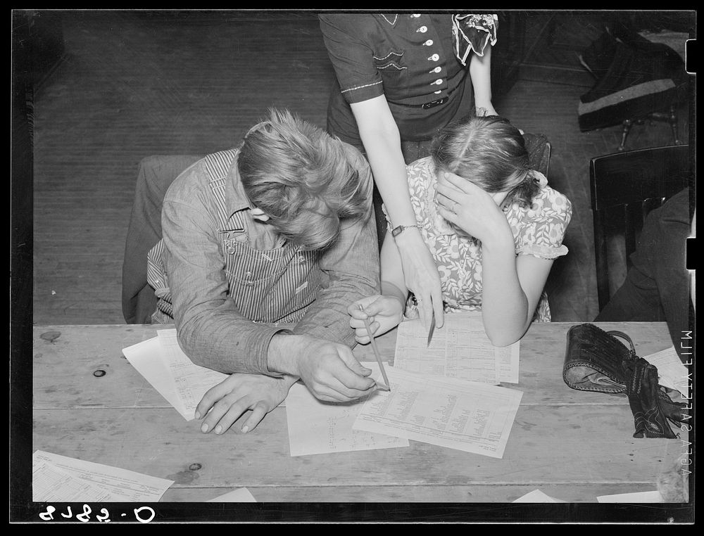Home supervisor helping young farm couple work out home plan. Group meeting, York, Nebraska. Sourced from the Library of…