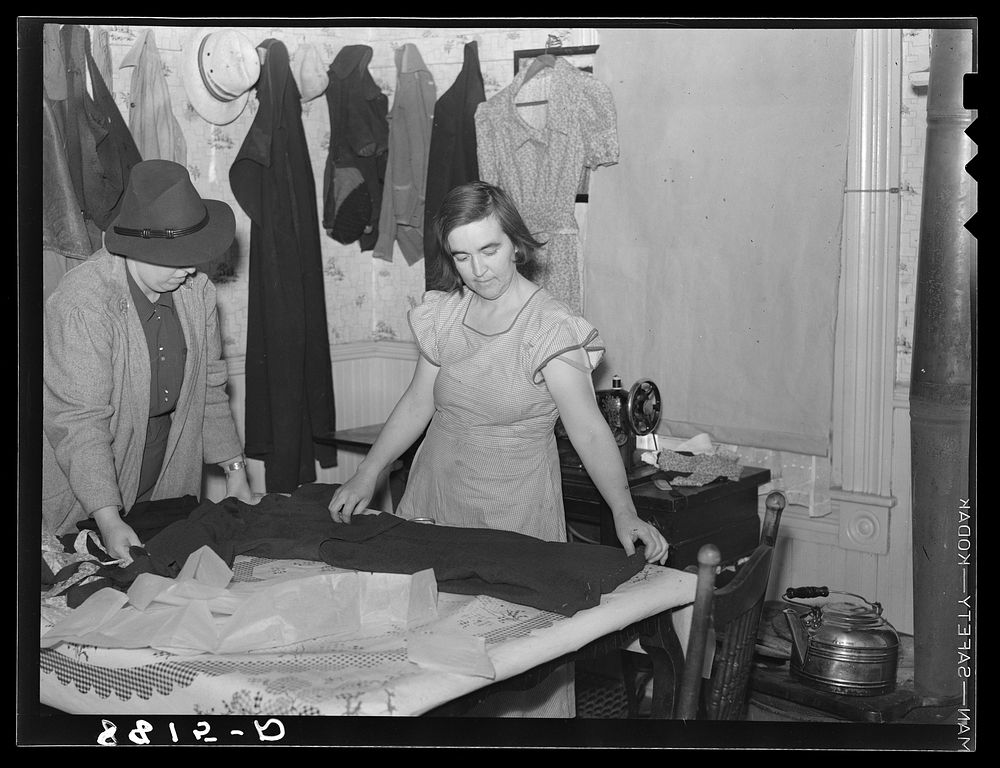 Farm Security Administration home supervisor helping rehabilitation client with sewing. Otoe County, Nebraska. Sourced from…