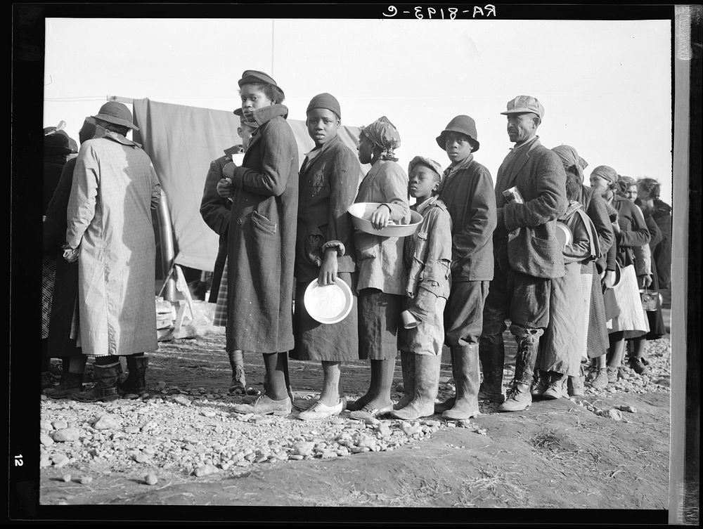 es waiting for food in the Forrest City, Arkansas, concentration camp. Sourced from the Library of Congress.