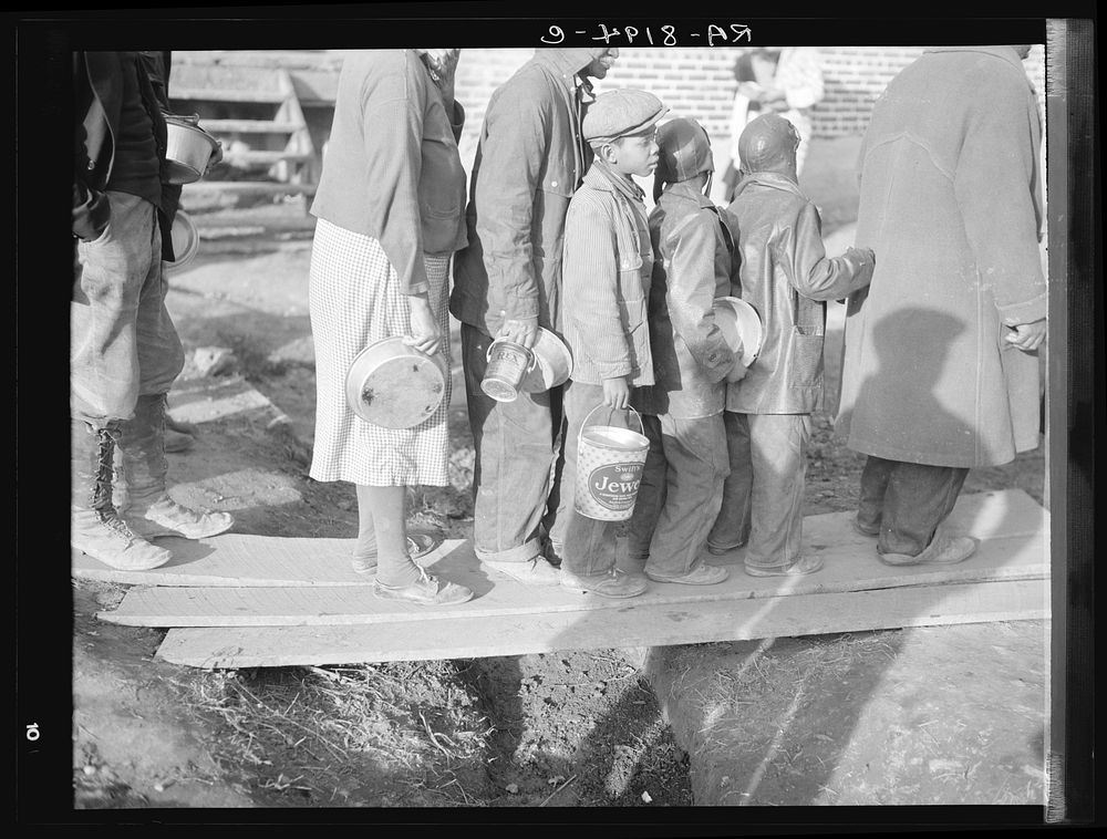 es waiting for food in the Forrest City, Arkansas, refugee camp. Sourced from the Library of Congress.