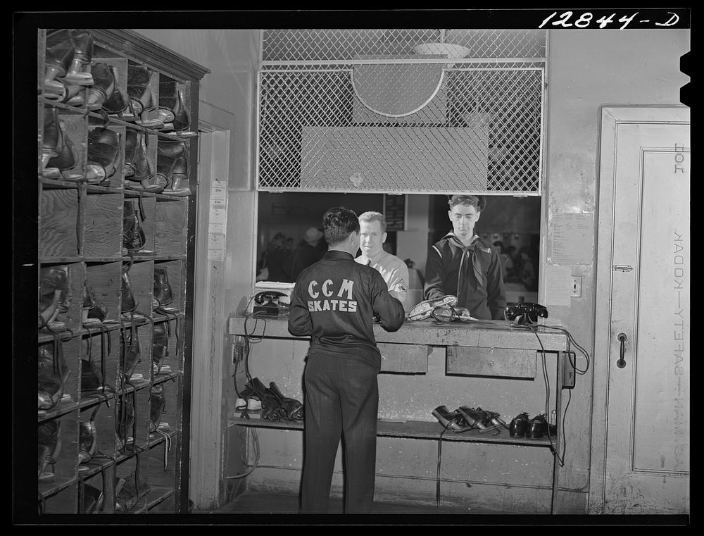 Chevy Chase Ice Palace, Washington. D.C. Servicemen returning skates which were rented to them for the evening by the Chevy…