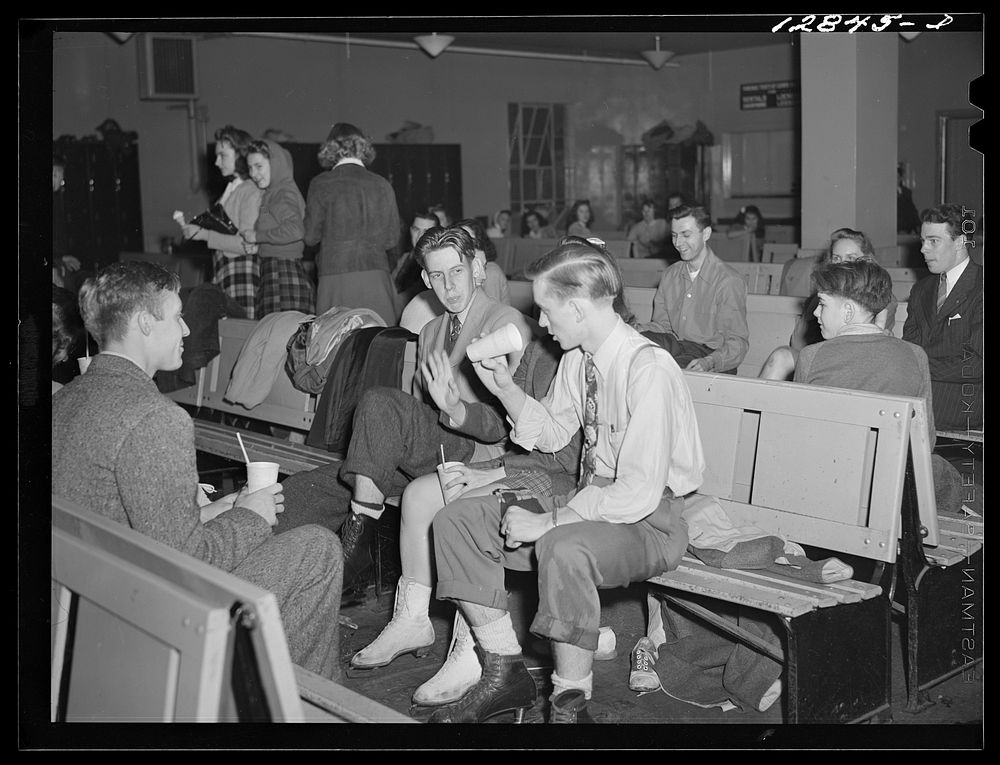 Chevy Chase Ice Palace, Washington. D.C. Skaters sitting down enjoying refreshments. Sourced from the Library of Congress.
