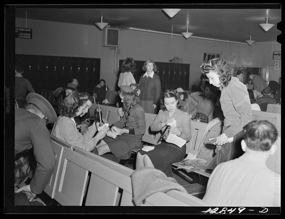 Chevy Chase Ice Palace, Washington. D.C. Girls cleaning and polishing skates before fastening them on. Sourced from the…