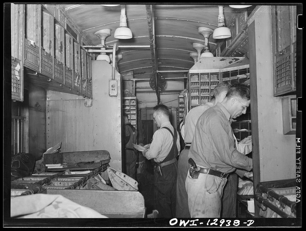 Sorting mail on board a mail car. Sourced from the Library of Congress.