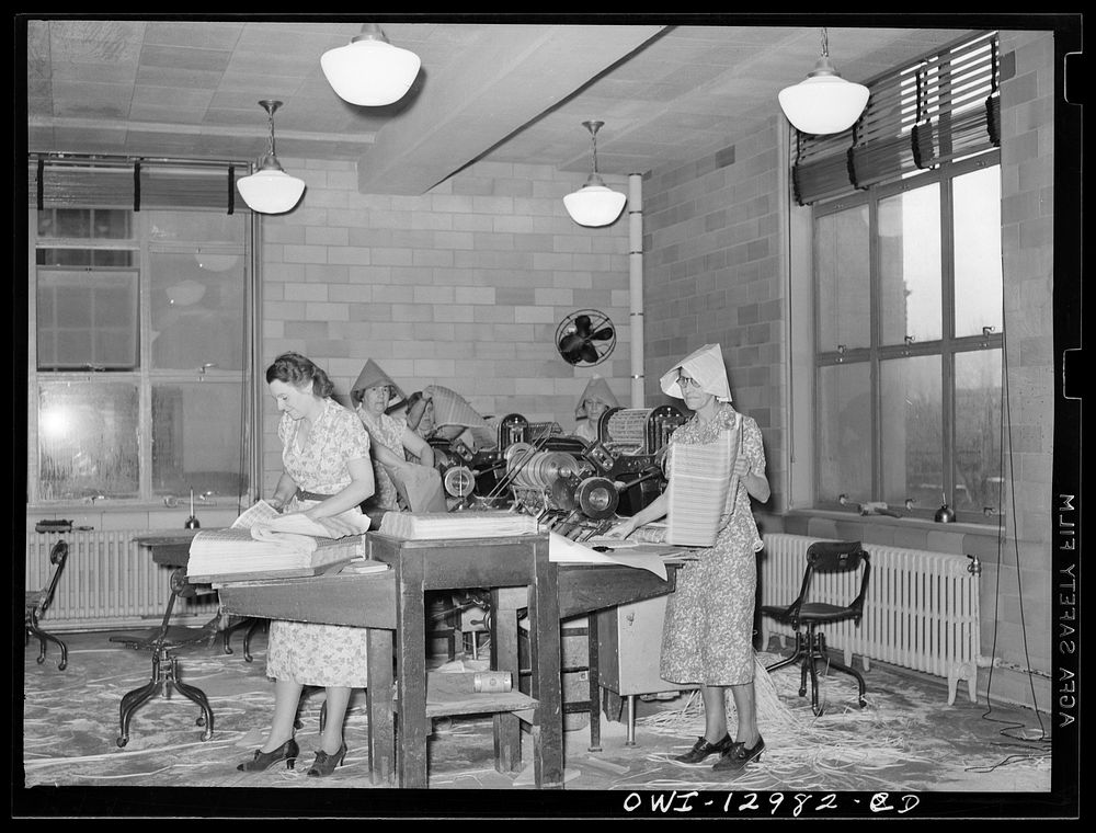 Washington, D.C. Perforating, examining and counting postage stamps at the United States Bureau of Engraving and Printing.…