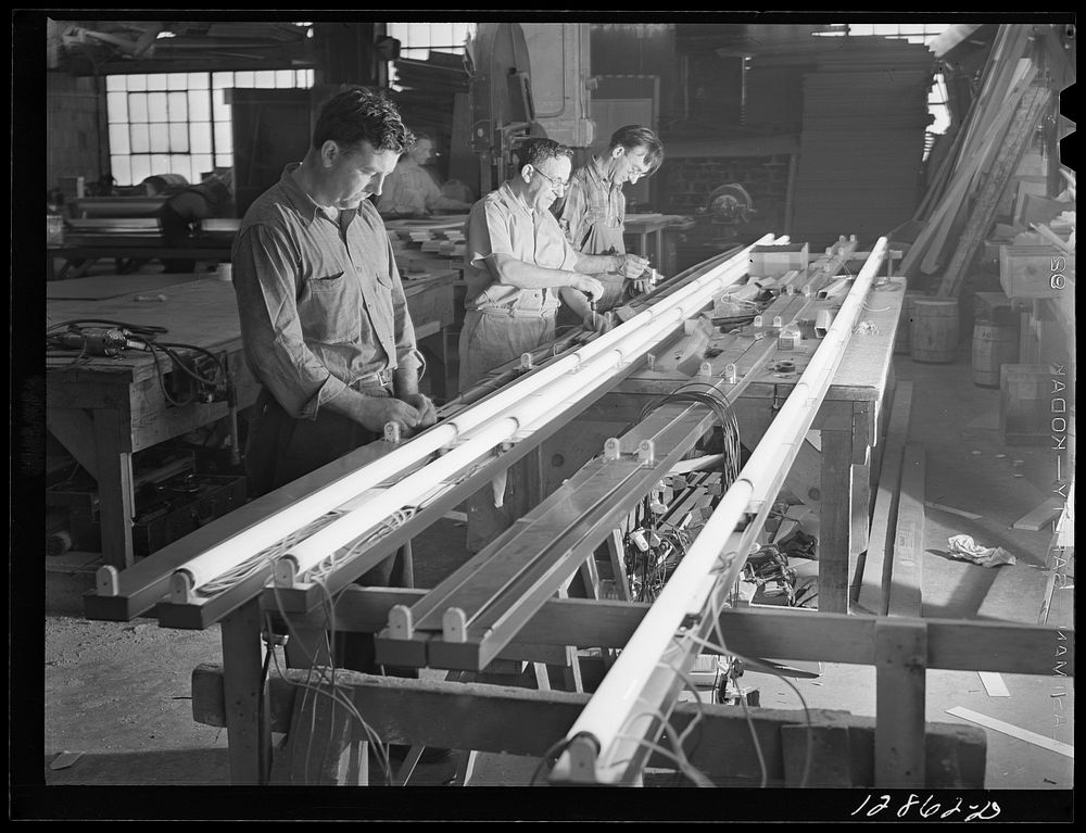 New York, New York. Preparing the defense bond sales photomural, designed by the Farm Security Administration, to be…