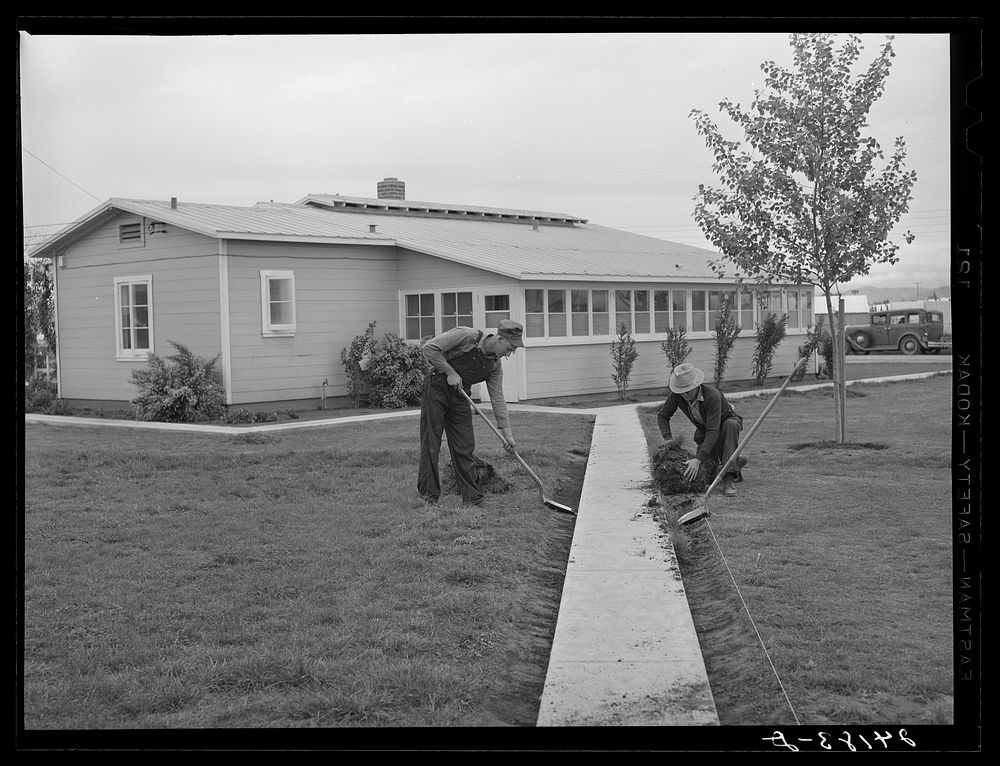 Migrants pay their rent when unemployed by working around the camp. Tulare migrant camp. Visalia, California. Sourced from…