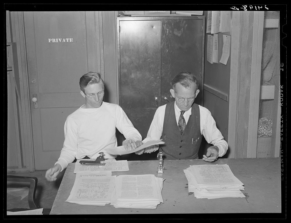Putting out newspaper. Tulare migrant camp. Visalia, California. Sourced from the Library of Congress.