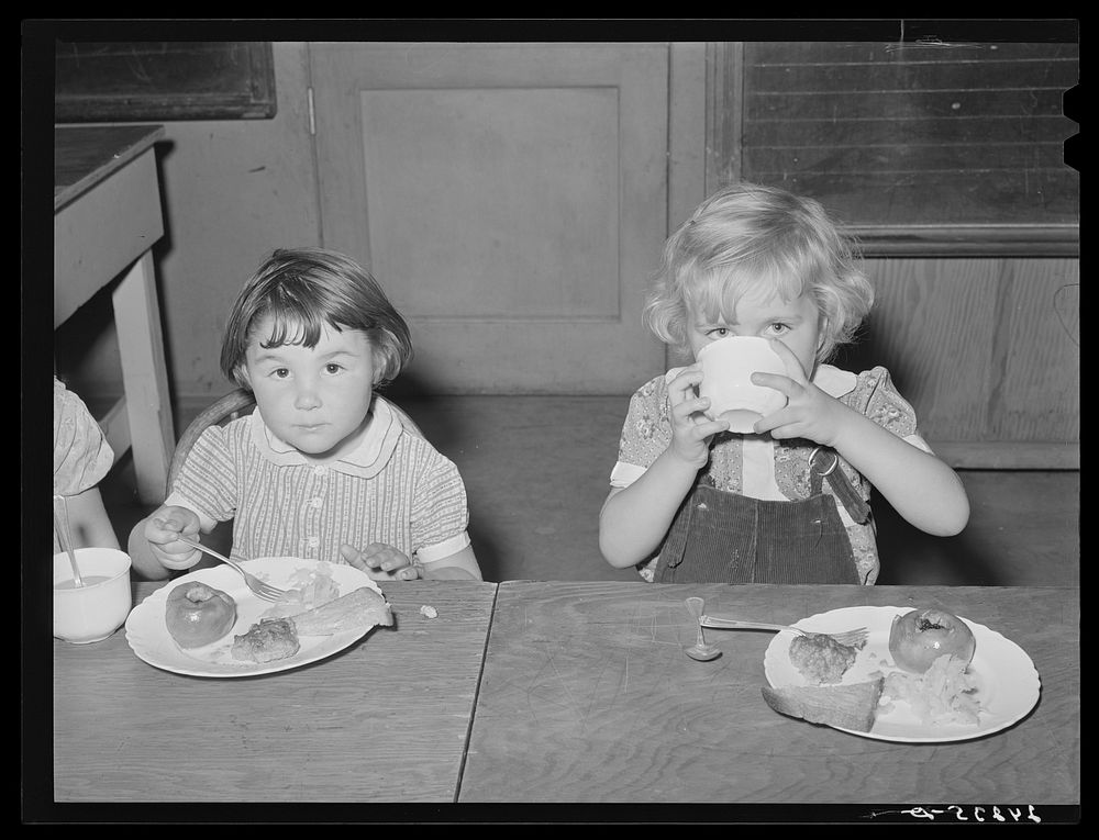 Children eating lunch in nursery. Tulare migrant camp. Visalia, California. Sourced from the Library of Congress.