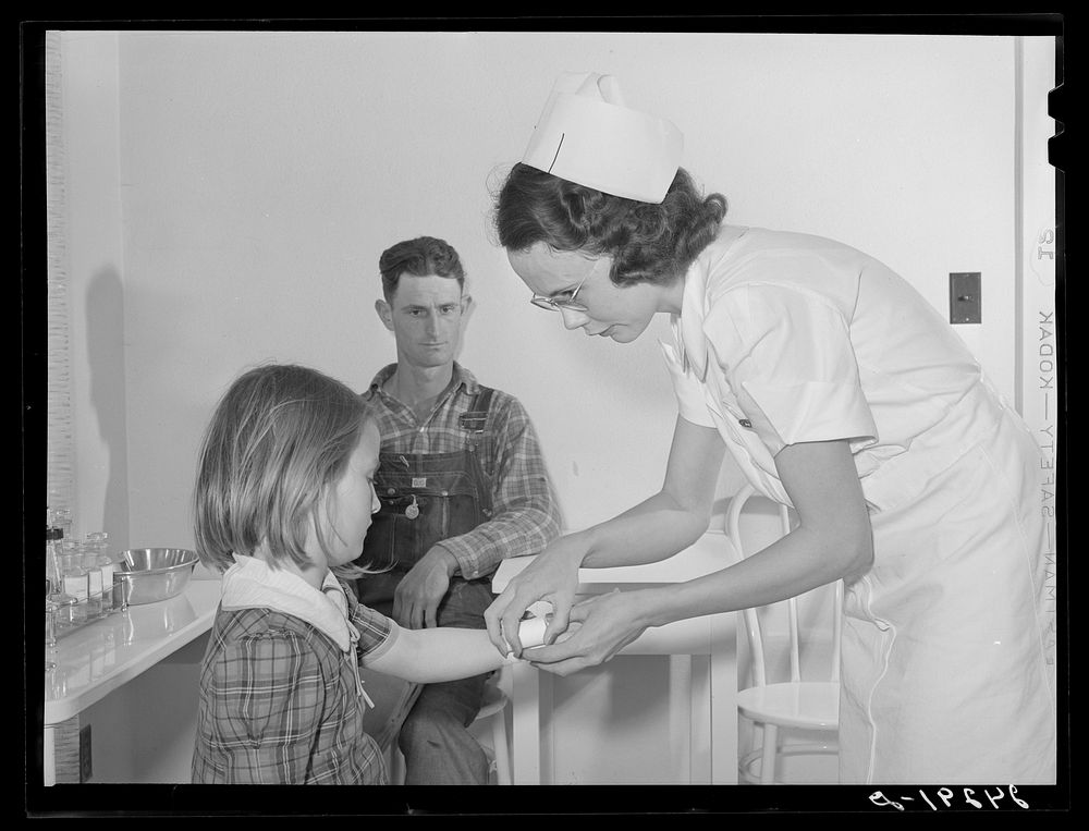 Nurse treating child in health clinic. Shafter migrant camp. Shafter, California. Sourced from the Library of Congress.