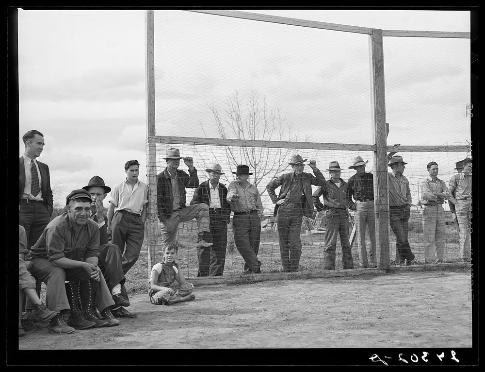Watching baseball game. Tulare migrant camp. Visalia, California. Sourced from the Library of Congress.