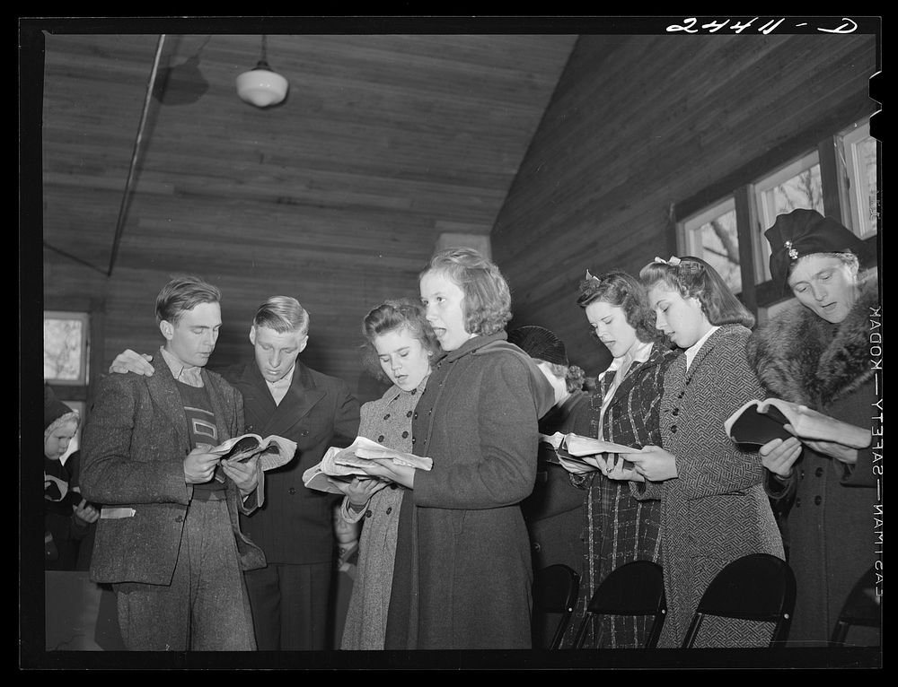 [Untitled photo, possibly related to: Group singing hymns at the opening of the Sunday school. While there are no churches…