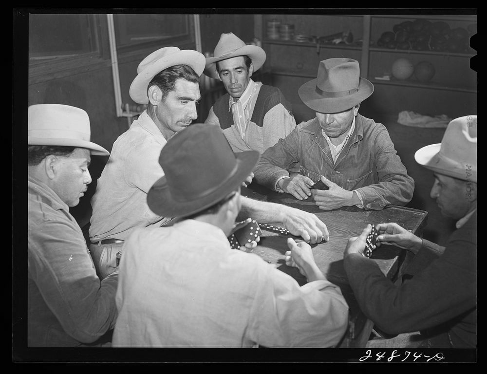 Domino game on Saturday night. Community center. Robstown camp, Texas. Sourced from the Library of Congress.