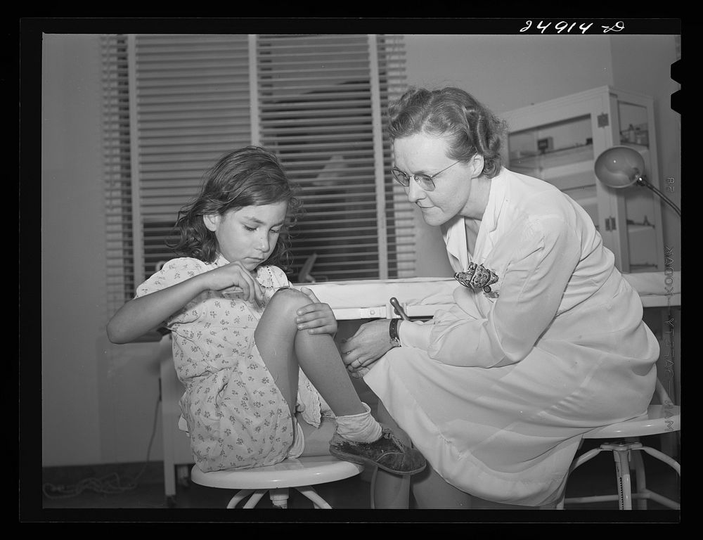 Robstown, Texas. FSA (Farm Security Administration) migratory workers camp. Young patient treating injury under supervision…