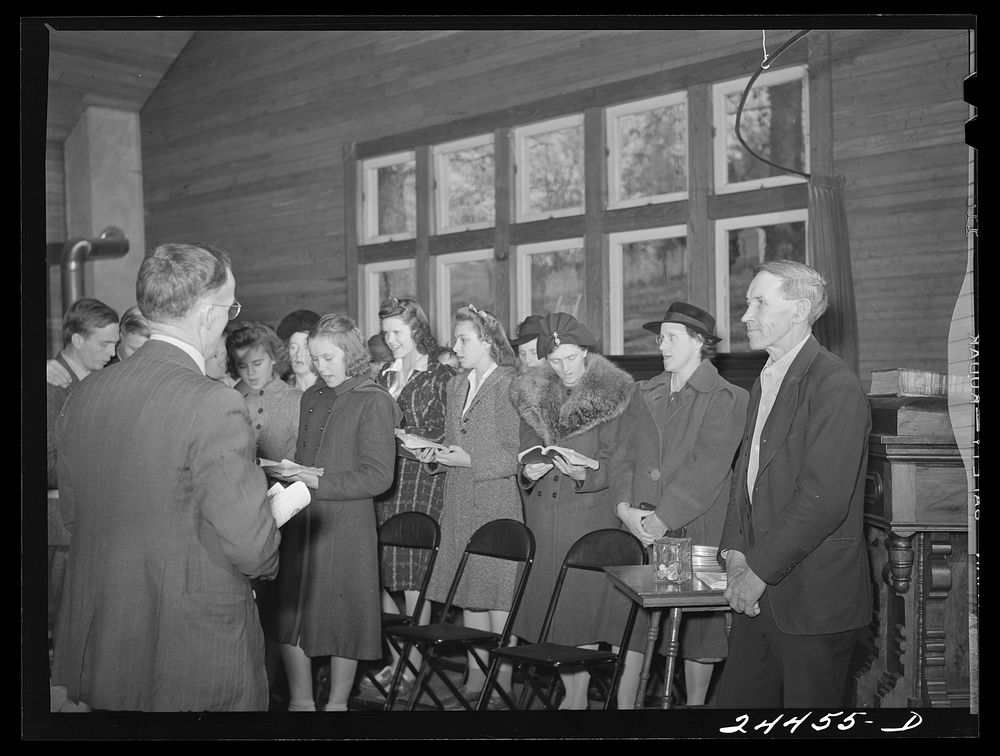 Group singing opening hymn. Sunday school. Dailey, West Virginia. Sourced from the Library of Congress.
