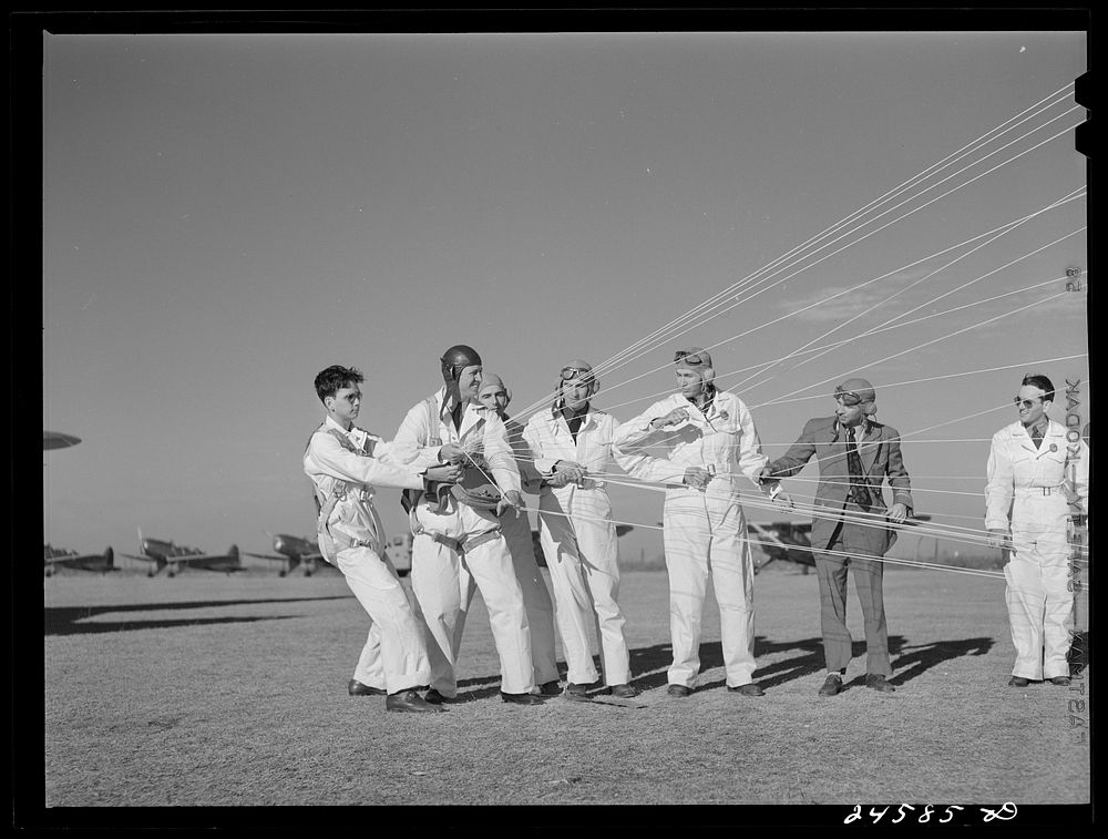 Instructor explaining operation of parachute to students. Meacham Field, Fort Worth, Texas. Sourced from the Library of…