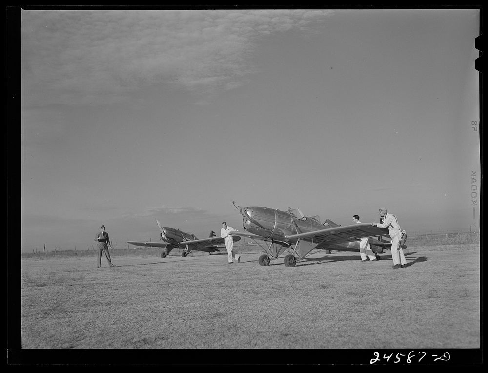 Students wheeling plane into position. Meacham Field, Fort Worth, Texas. Sourced from the Library of Congress.