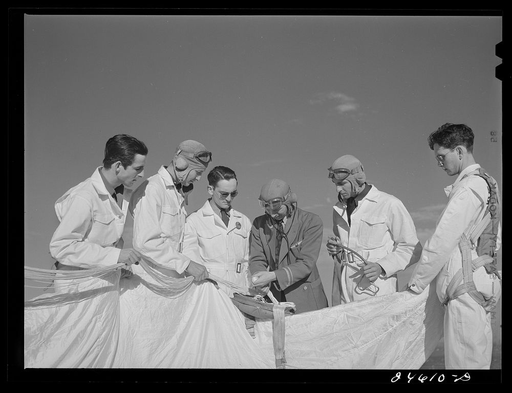 Instructor explaining operation of parachute to student pilots. Meacham Field, Fort Worth, Texas. Sourced from the Library…
