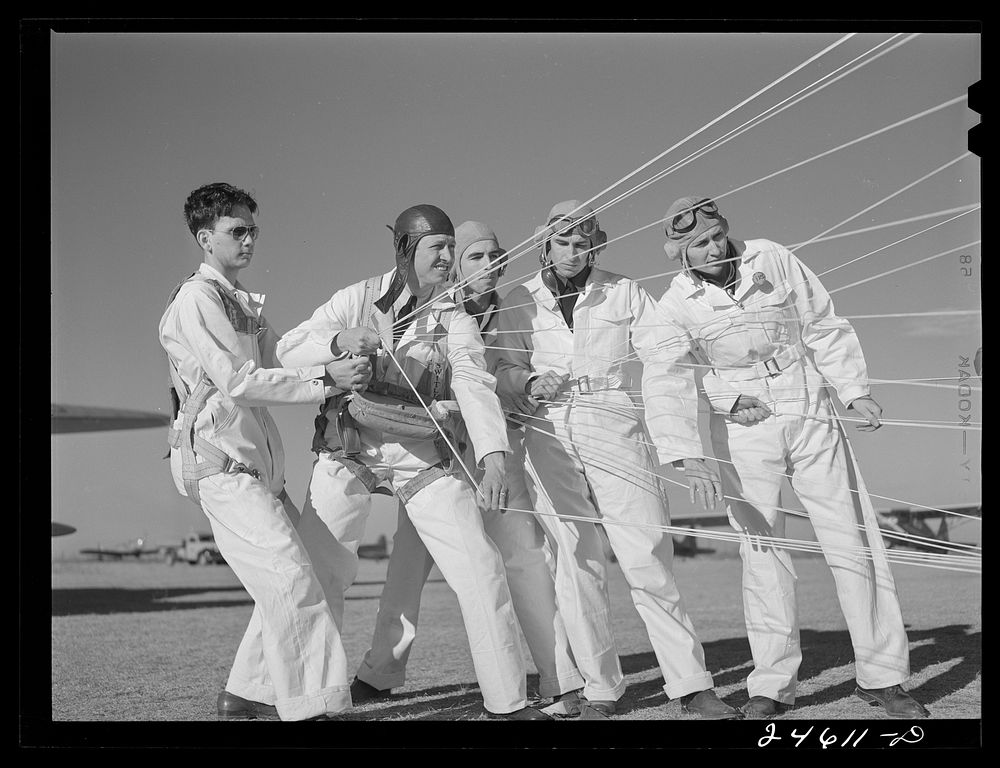 Instructor explaining operation of parachute to student pilots. Meacham Field, Fort Worth, Texas. Sourced from the Library…