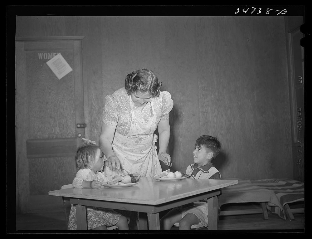 Robstown, Texas. FSA (Farm Security Administration) migratory workers' camp. Migratory worker's wife serving lunch to…