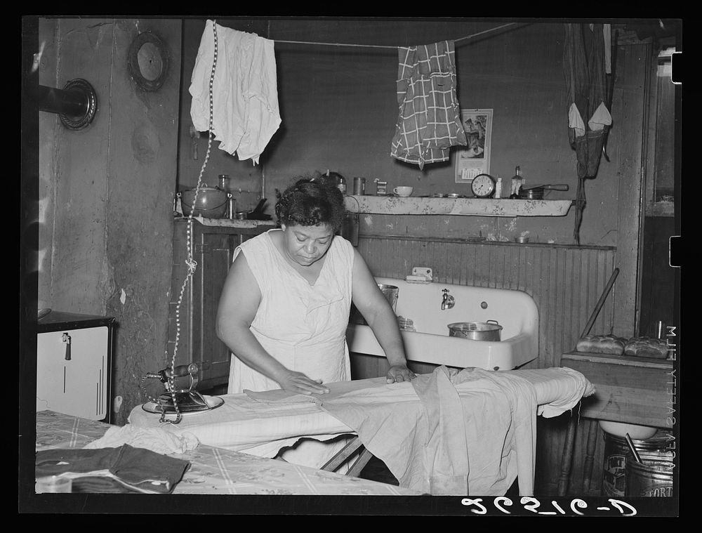 Steel worker's wife ironing clothes. Midland, Pennsylvania. Sourced from the Library of Congress.
