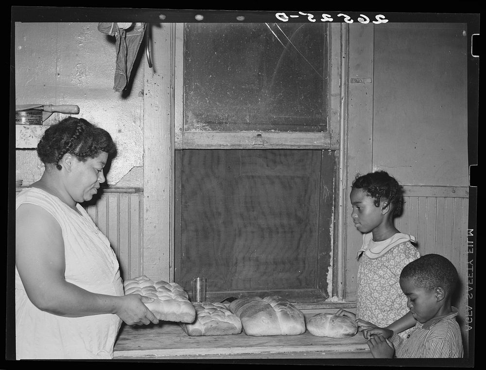 Wife of steel worker with bread she has baked. Midland, Pennsylvania. Sourced from the Library of Congress.