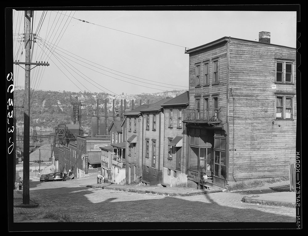 Workers' homes with steel plant along Monongahela River in background. Clairton, Pennsylvania. Sourced from the Library of…