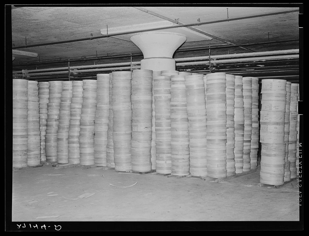 Stacks of cheese in cold storage warehouse, Jersey City, New Jersey, in "cooler room". Sourced from the Library of Congress.