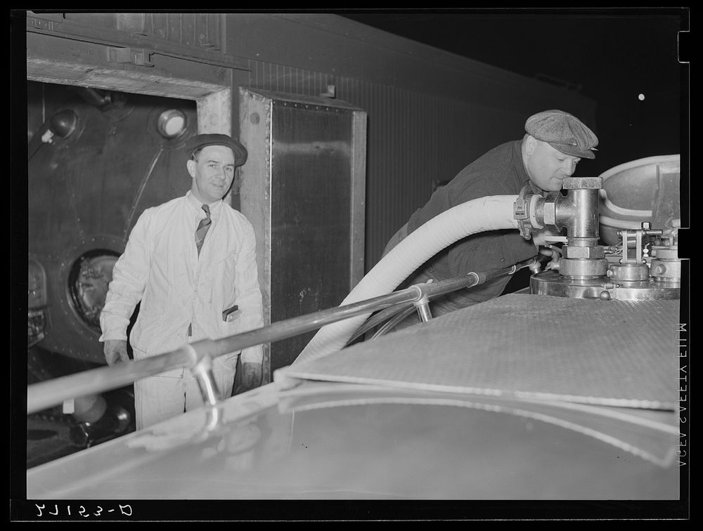 [Untitled photo, possibly related to: Transferring milk from tank car to truck. Jersey City, New Jersey]. Sourced from the…