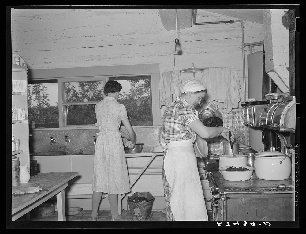 Cook and hired girl in kitchen. Quarter Circle 'U' Ranch, Montana. Sourced from the Library of Congress.