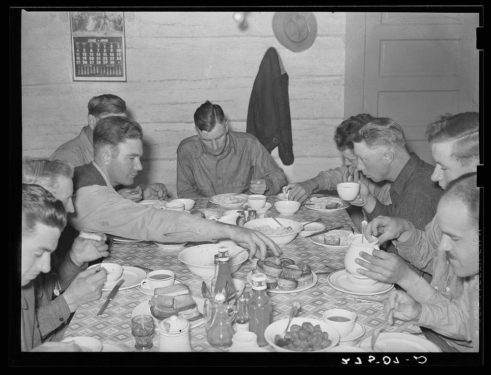 Cowhands at dinner. Quarter Circle 'U' Ranch, Montana. Sourced from the Library of Congress.