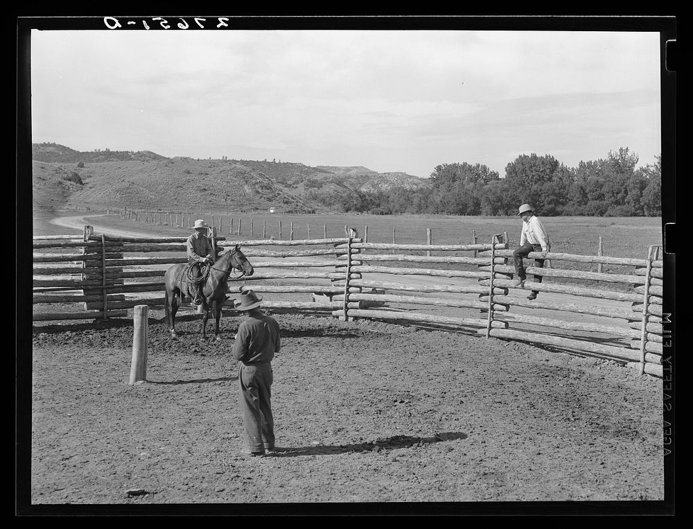 [Untitled photo, possibly related to: Giving directions to visiting cowhand. Quarter Circle 'U' Ranch, Montana]. Sourced…