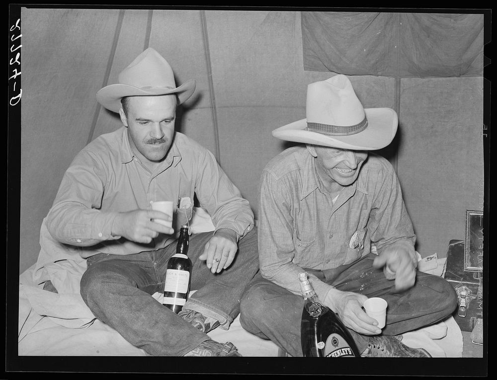 Cowhands relaxing at Quarter Circle 'U' roundup. Big Horn County, Montana. Sourced from the Library of Congress.