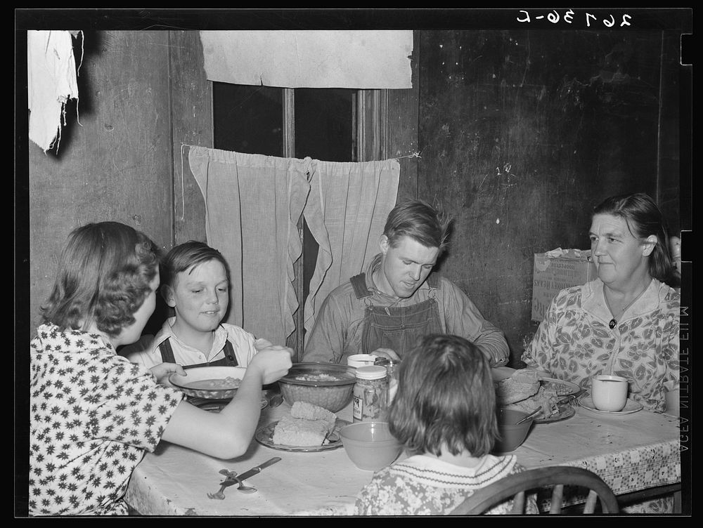 WPA (Works Progress Administration) worker and family at dinner. Zeigler, Illinois. Sourced from the Library of Congress.