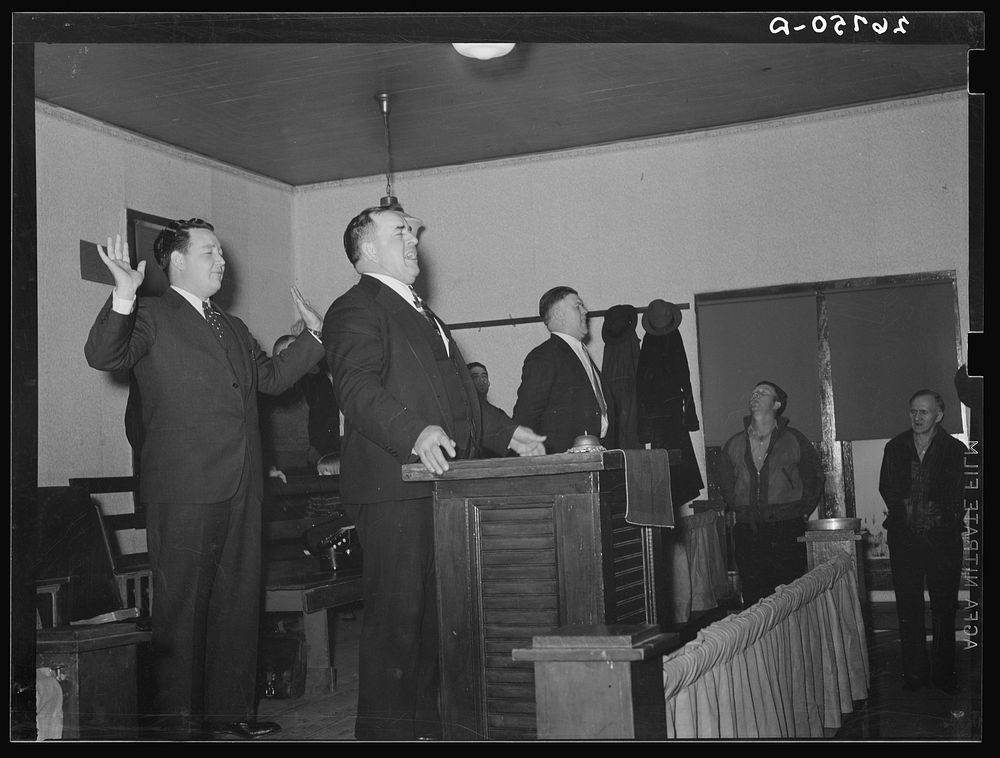 Prayer during revival meeting. Pentecostal church, Cambria, Illinois. Sourced from the Library of Congress.