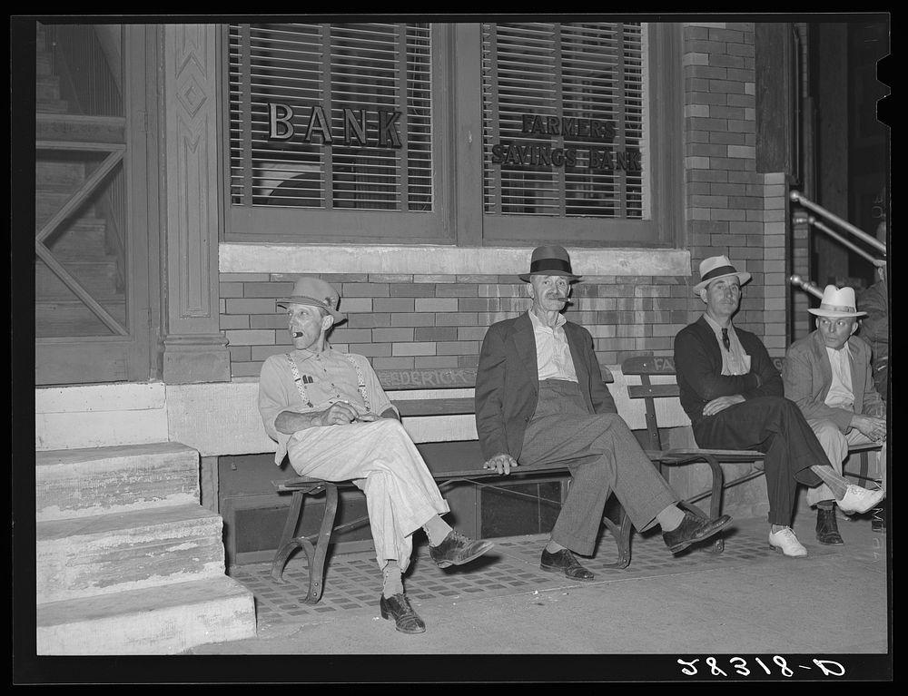 Farmers in town on Saturday night. Grundy Center, Iowa. Sourced from the Library of Congress.