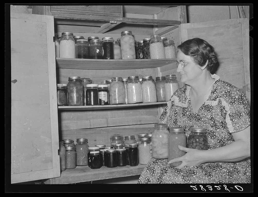 Mrs. Andy Bahain with fruit and vegetables produced on their farm near Kersey, Colorado. Sourced from the Library of…