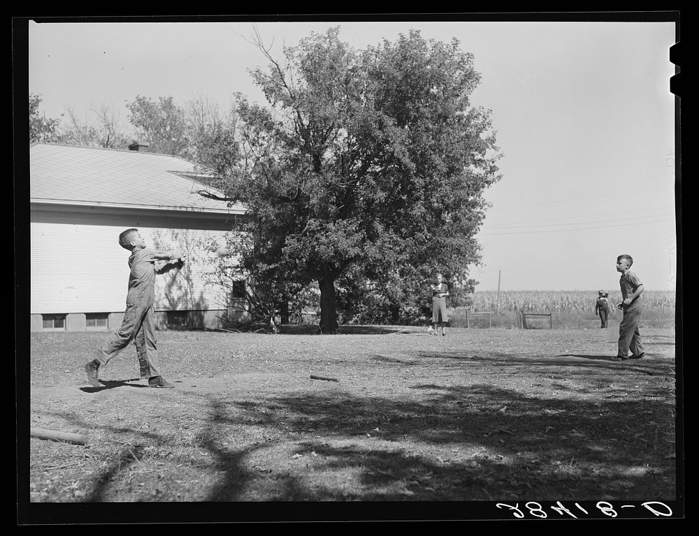 [Untitled photo, possibly related to: Teacher supervises ball game during recess period. Grundy County, Iowa]. Sourced from…
