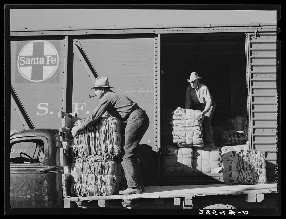Farmers unload new potato sacks brought by growers' co-operative. Monte Vista, Colorado. Sourced from the Library of…