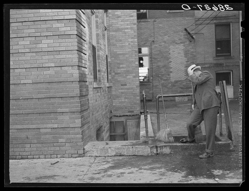 [Untitled photo, possibly related to: Cattle buyer cleaning his shoes after trip through the stockyards. Denver, Colorado].…