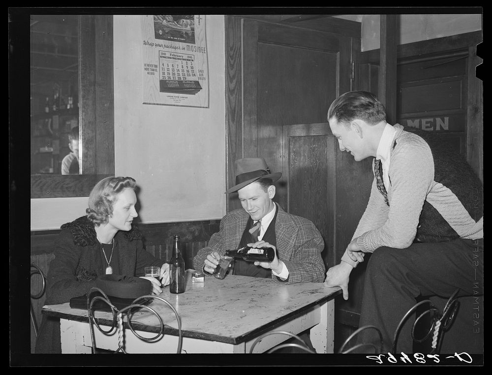 Between dances, couples relax in adjoining beer parlor. Marshalltown, Iowa. Sourced from the Library of Congress.