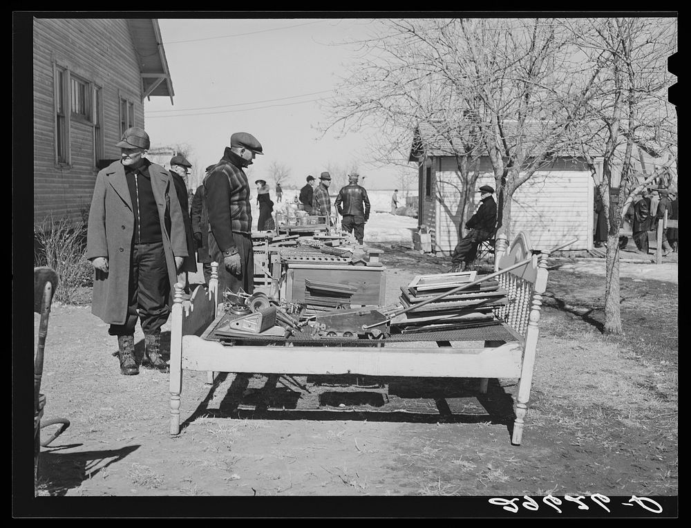 Neighbors examine furniture to be auctioned at P.C. Zimmerman's farm near Hastings, Nebraska. Sourced from the Library of…