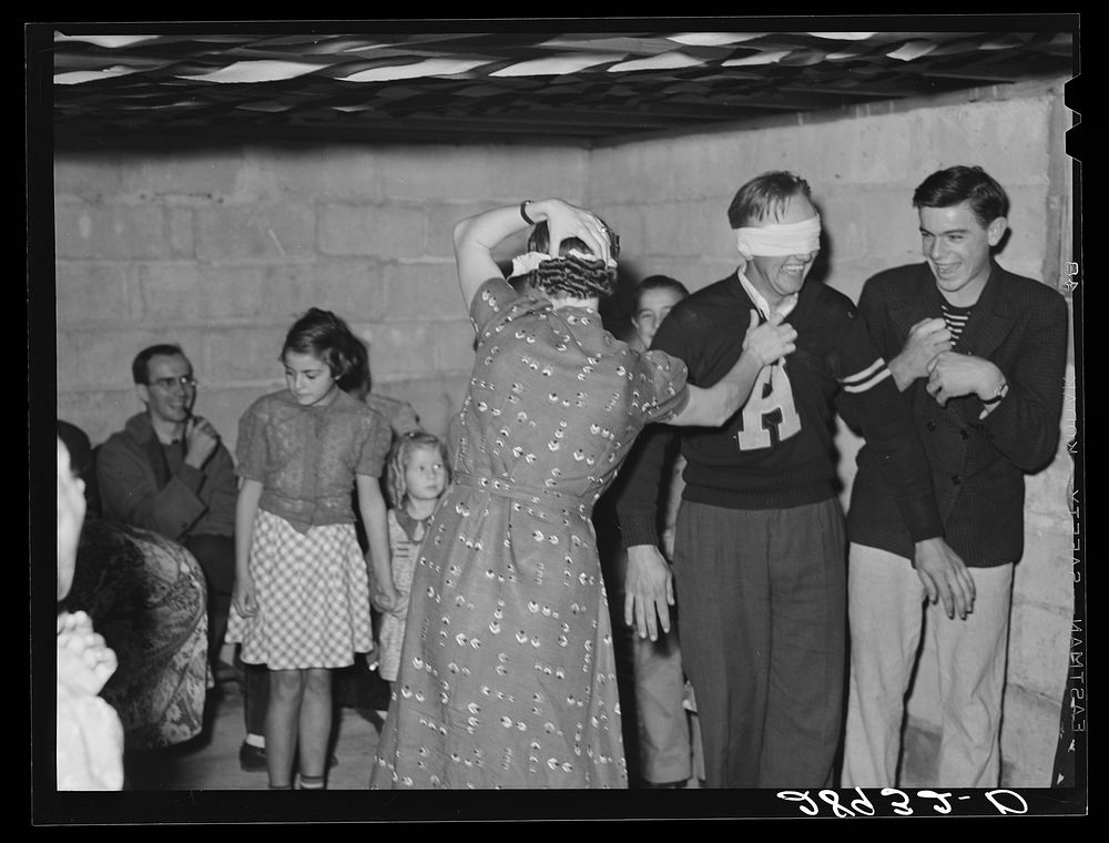 "Hiram & Mirandy" game played at Halloween party. Hillview Cooperative, Osage Farms, Missouri. Sourced from the Library of…