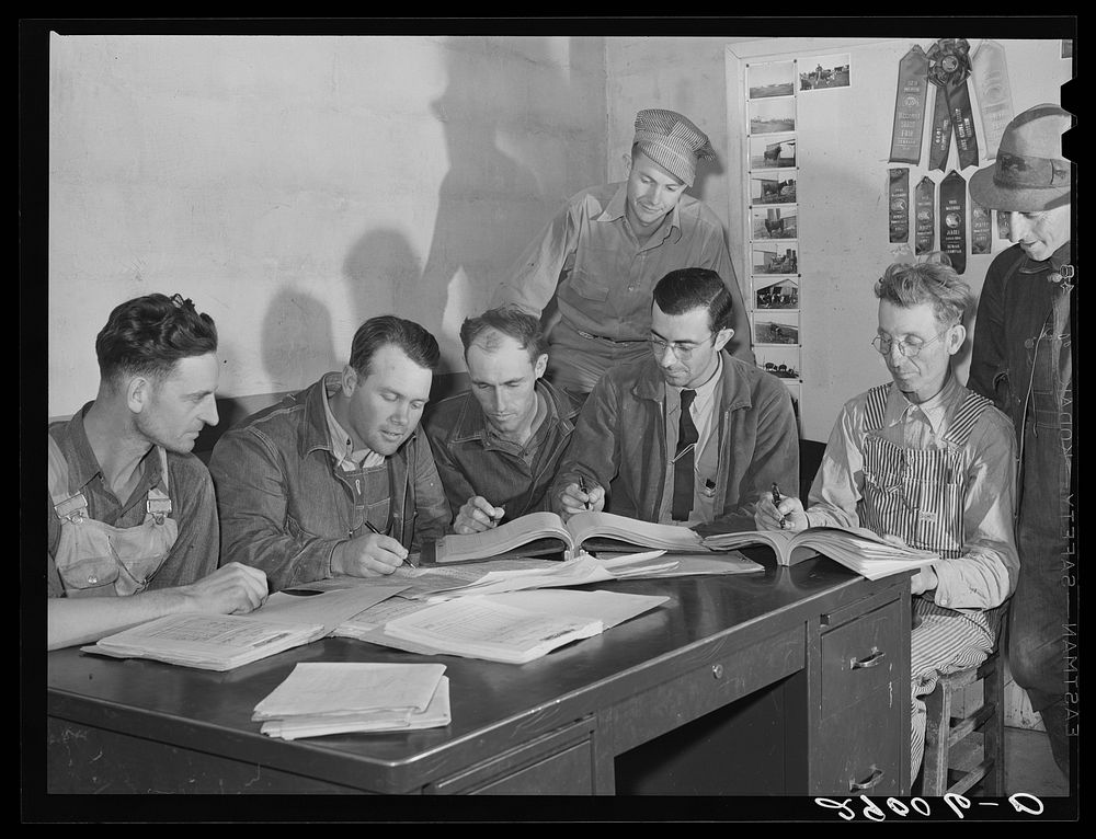 Members of the Bois d'Arc Cooperative looking over their accounts. Osage Farms, Missouri. Sourced from the Library of…