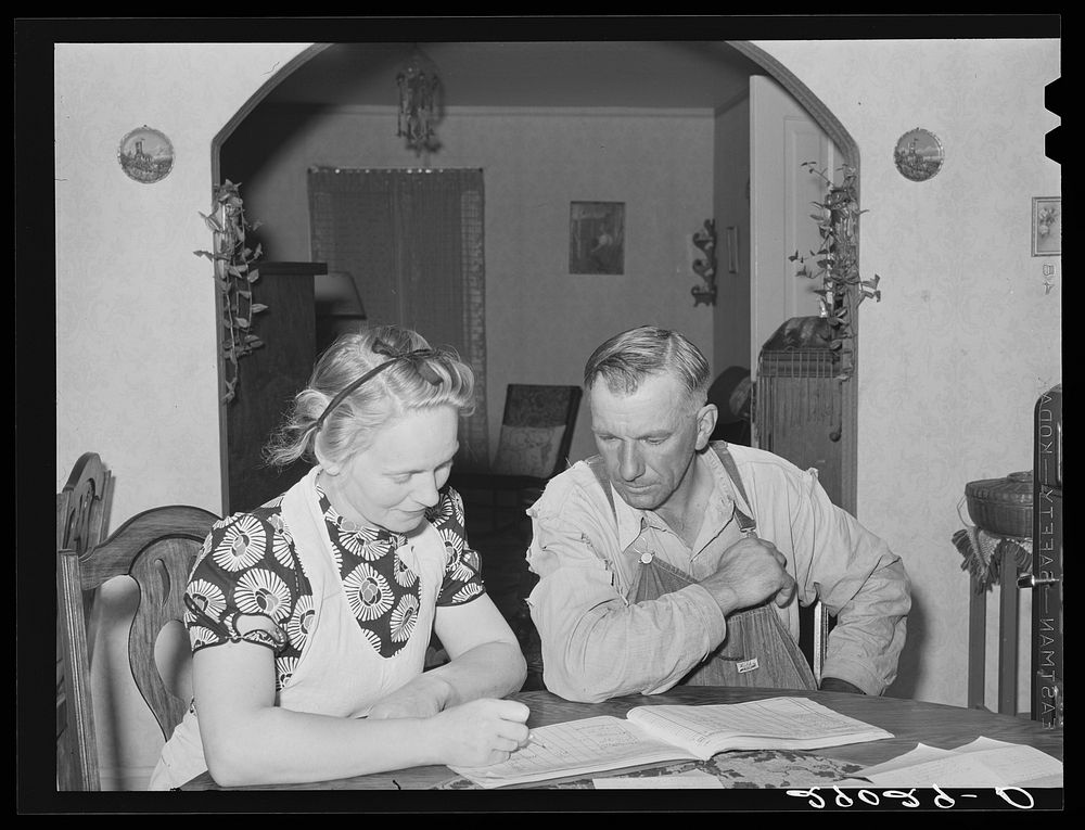 Mr. and Mrs. Fred Maschman going over their record book discuss ways of making their new farm, purchased with FSA (Farm…