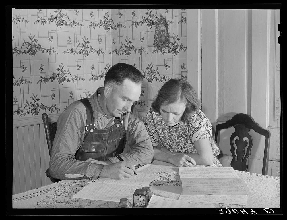 Fred Wilfang, rehabilitation client, goes over his farm plan with his wife. They have twenty hogs, ten milk cows, 250…