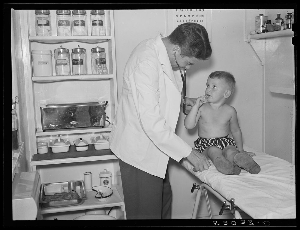 Examining child in medical center. Greenbelt, Maryland. Sourced from the Library of Congress.